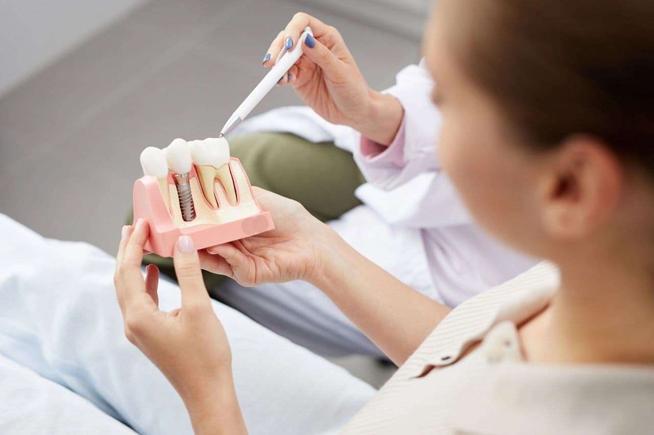 A patient seeing a model of an implant