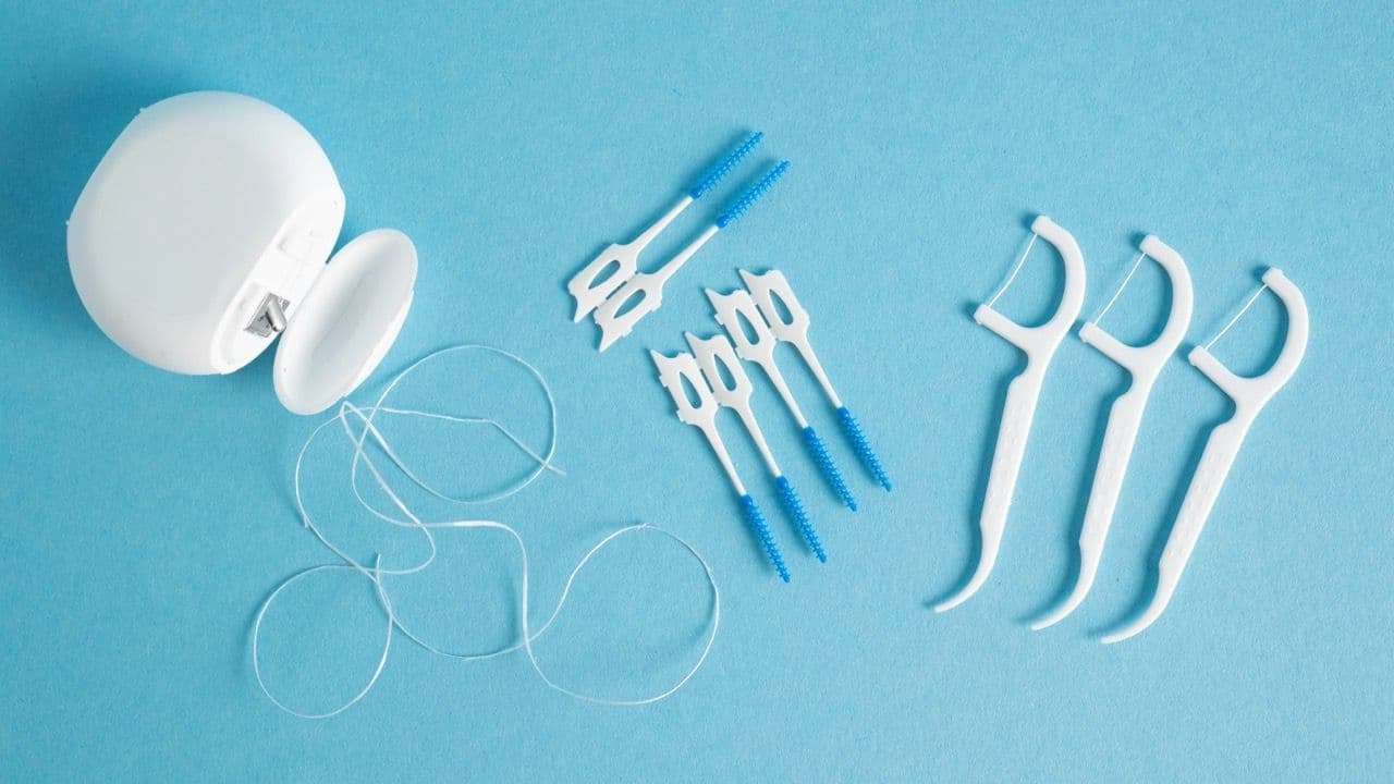 Photo of various flossing tools shot from above.