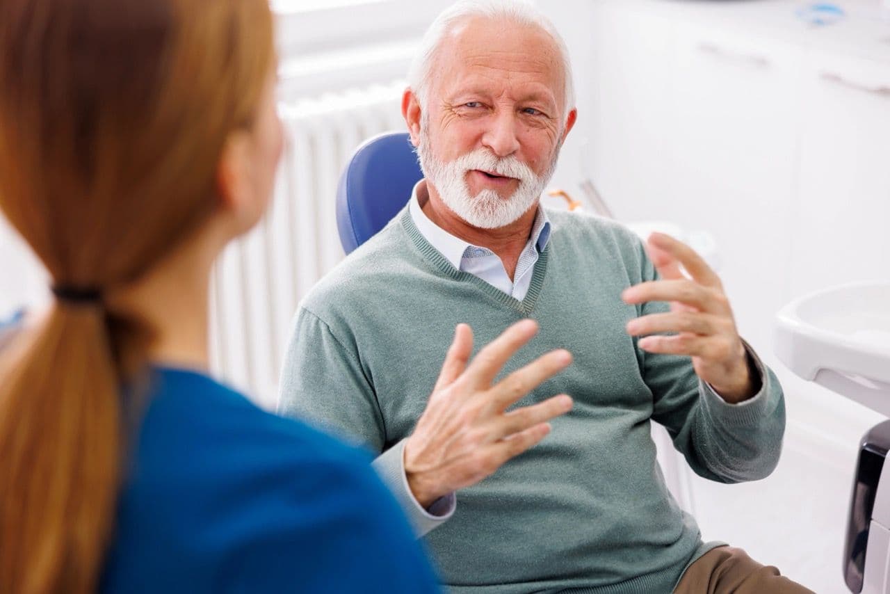 Photo of a patient and dentist communicating with each other